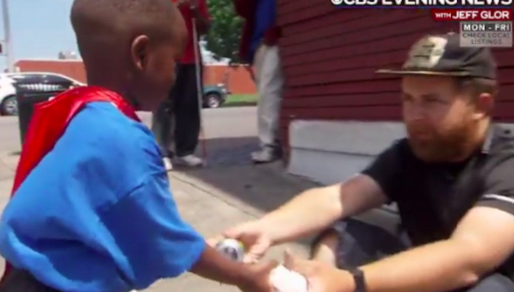 Black kid helps White homeless people by giving them food