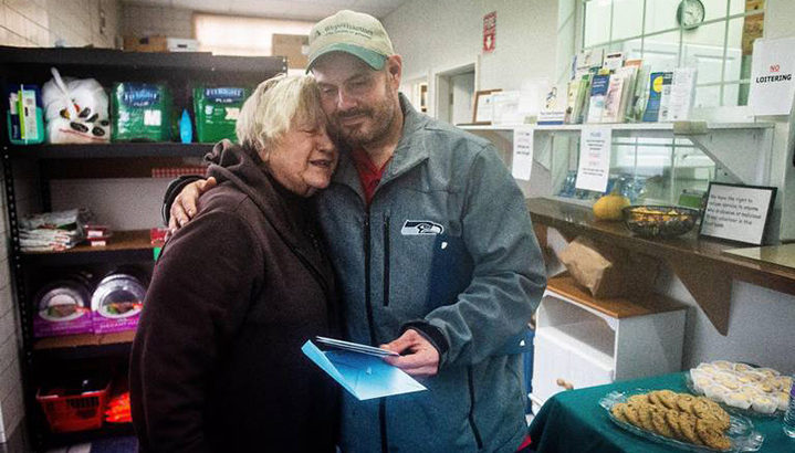 White homeless man finds money and gives it to a food bank.